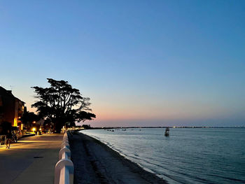 Scenic view of sea against clear sky at sunset