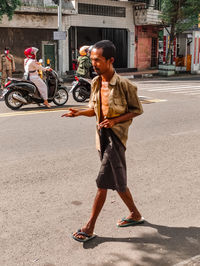 Low section of man walking on street