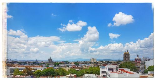 Cityscape against cloudy sky