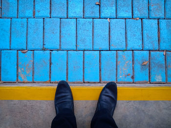 Low section of man standing on swimming pool