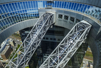 High angle view of footbridge by building in city