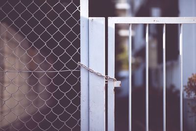 Gate locked with metal chain and padlock