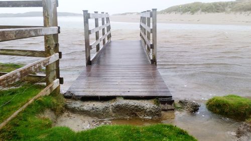 A flooded  beach path and wooden walkway by the sea. no way out.