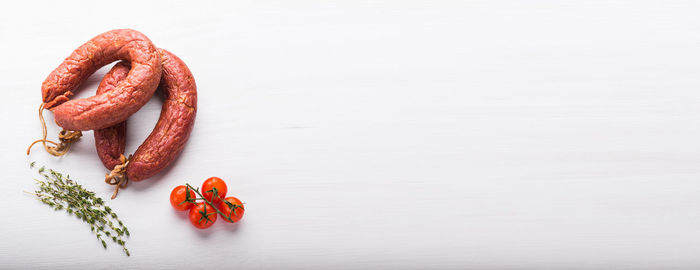 Close-up of red chili peppers on white background