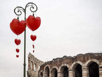 Low angle view of heart shape against sky