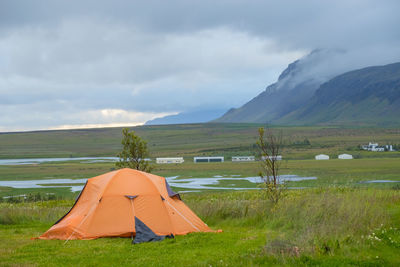 Tent on field against sky