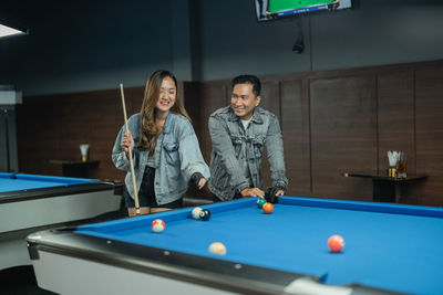 Portrait of woman playing pool