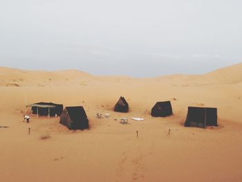 Sand dunes in desert against sky