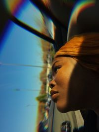 Close-up portrait of young woman looking away