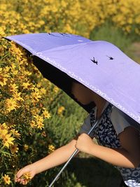 Midsection of girl holding umbrella