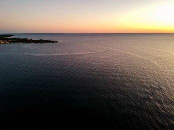 Scenic view of sea against clear sky during sunset