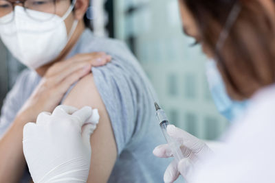 Midsection of doctor examining patient