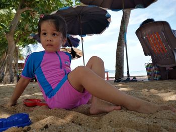 Cute girl sitting on beach