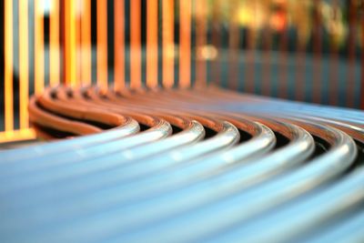 Close-up of curved metallic bench