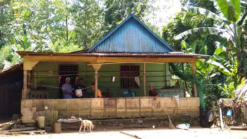 People sitting outside house