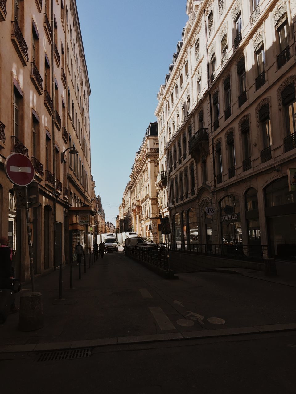 STREET AMIDST BUILDINGS AGAINST SKY