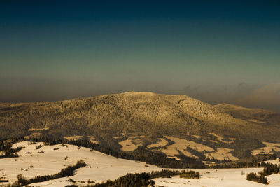 Scenic view of snowcapped mountain against sky