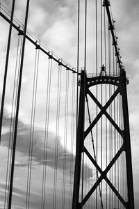 Low angle view of suspension bridge against sky, vancouver
