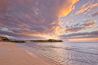 Scenic view of beach against sky during sunset