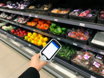 Midsection of man having food in store