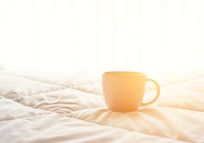 Coffee cup on bed