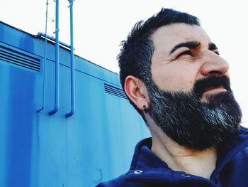 Close-up of man looking away standing outdoors