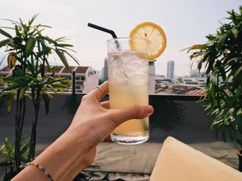 Midsection of man holding drink