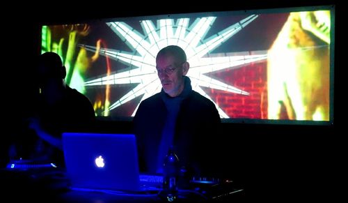 Man and woman standing in illuminated nightclub