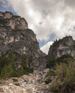 Low angle view of rocky mountains against sky