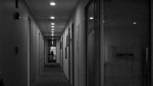 Man walking in illuminated corridor