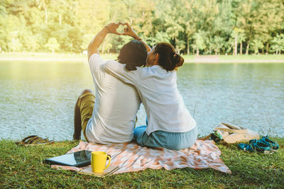 Rear view of women sitting in water