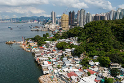 High angle view of buildings by sea against sky