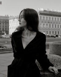 Portrait of young woman standing on street