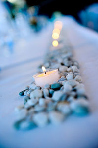 Close-up of burning candles on table