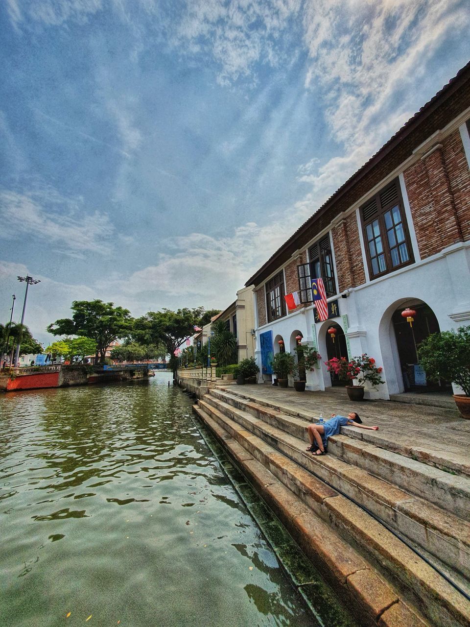 CANAL AMIDST BUILDINGS AGAINST SKY