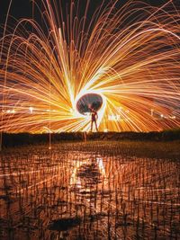 Low angle view of firework display at night
