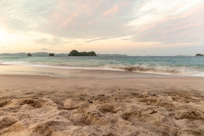 Scenic view of beach against sky during sunset