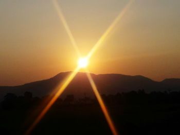 Scenic view of silhouette mountains against sky during sunset