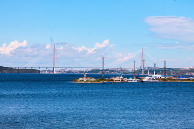 Sailboats in sea against blue sky