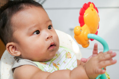 Portrait of cute baby boy with toy