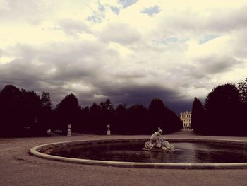 Scenic view of landscape against storm clouds