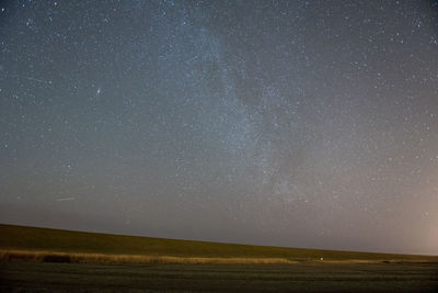 Scenic view of field against sky with star field