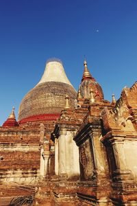 Low angle view of historical building against clear blue sky