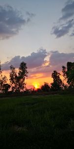 Scenic view of field against sky during sunset