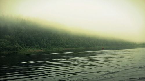 Scenic view of lake in foggy weather