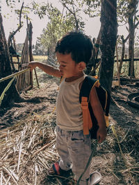 Baby boy standing at farm