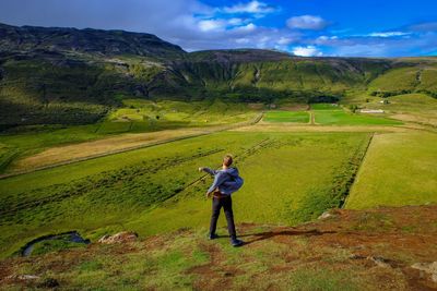 Full length of man standing on field against sky