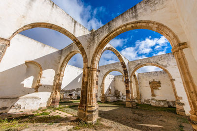 Low angle view of old ruins against sky