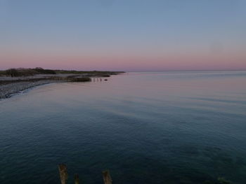 Scenic view of sea against clear sky during sunset