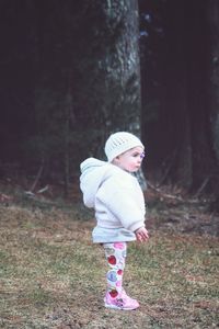 Cute baby girl standing outdoors